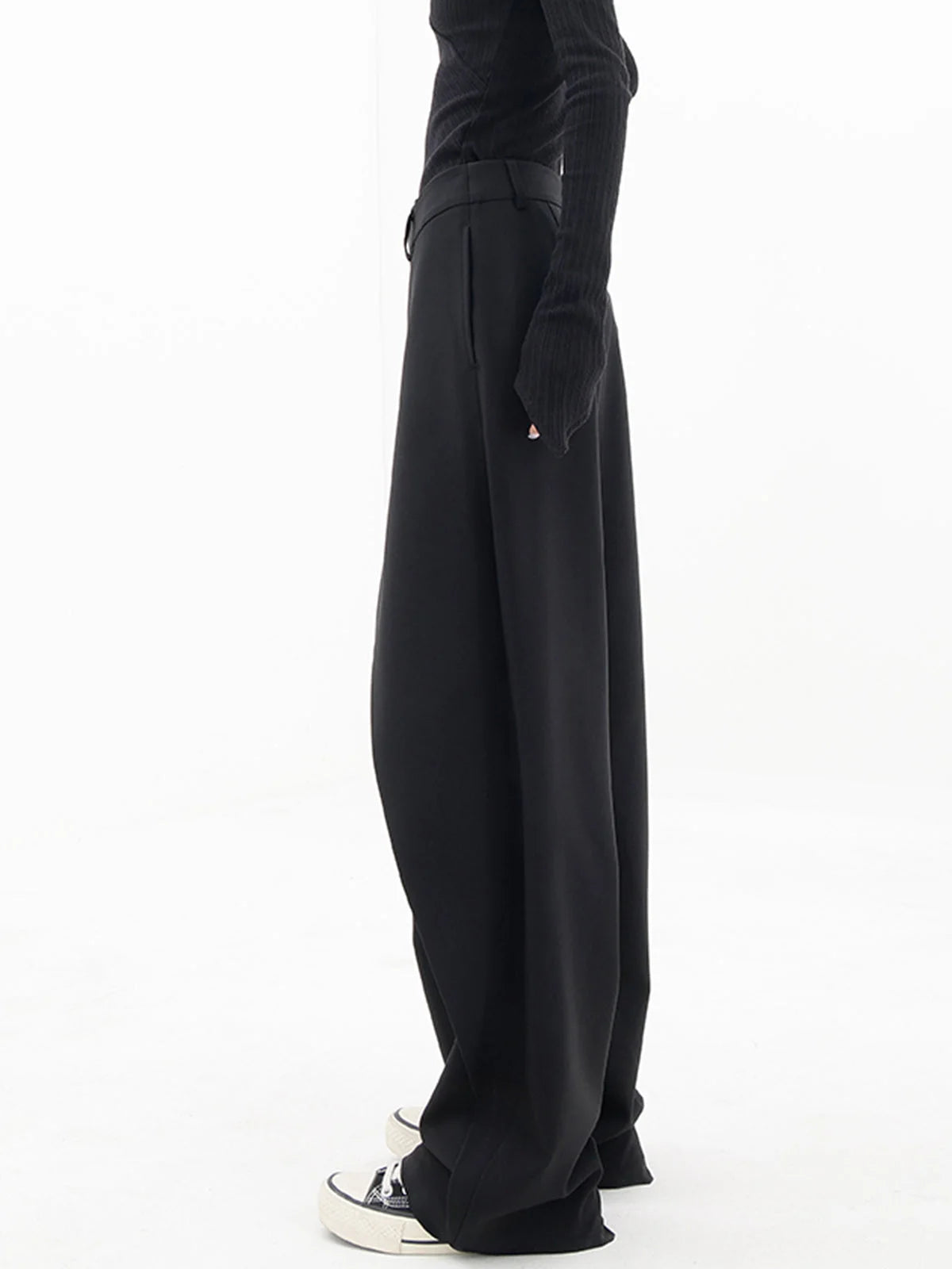 Alt text: Asymmetrical wide-leg dress pants with button details, crafted from soft fabric for comfort and a unique…
