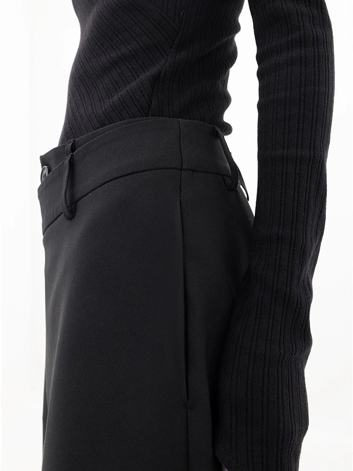 Asymmetrical layer wide-leg dress pants featuring button details, made from soft, flowing fabric for a relaxed fit.