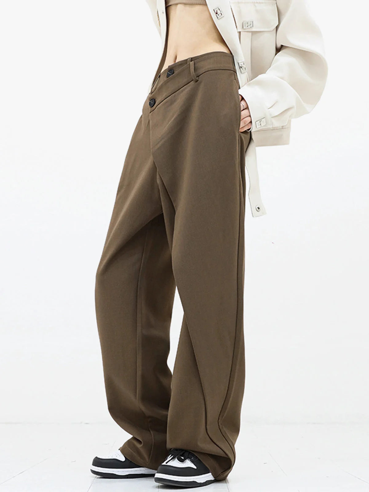Asymmetrical layer wide-leg dress pants featuring button details, made from soft, breathable fabric for comfort and style.