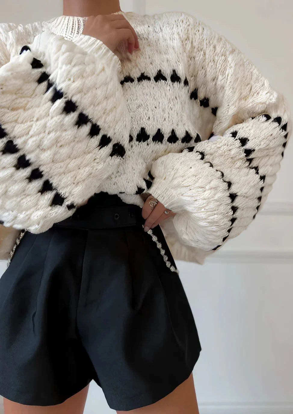 Cozy textured sweater featuring a patterned design, crafted from soft knit material for warmth and comfort.