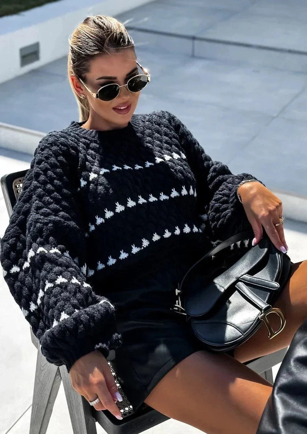 Cozy textured sweater featuring a patterned design, made from soft fabric, perfect for layering in cooler weather.