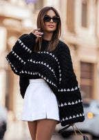 Cozy textured sweater featuring a patterned design, crafted from soft fabric for warmth and comfort in cooler weather.