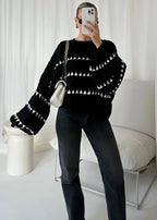 Cozy textured sweater featuring a patterned design, made from soft fabric, perfect for cooler weather.