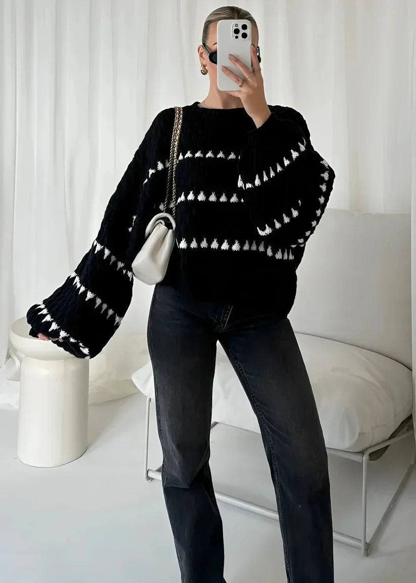 Cozy textured sweater featuring a patterned design, made from soft fabric, perfect for cooler weather.