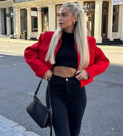 Stylish red cropped blazer with pockets, featuring a tailored fit and lightweight fabric for a modern look.