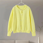 Women's animal print button-up cardigan made of soft knit material with long sleeves and a versatile, relaxed fit.
