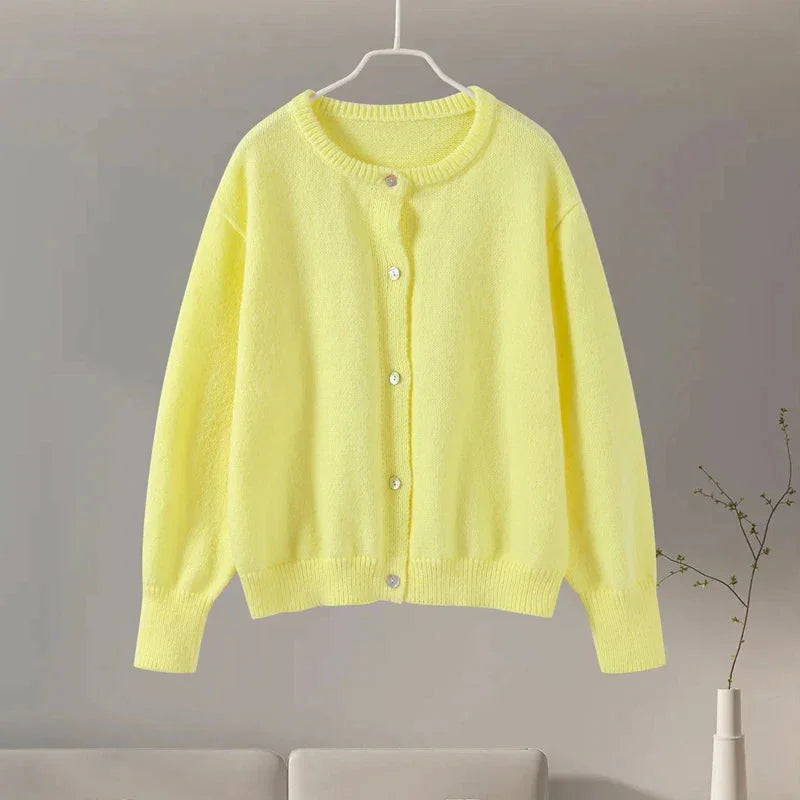 Women's animal print button-up cardigan made of soft knit material with long sleeves and a versatile, relaxed fit.