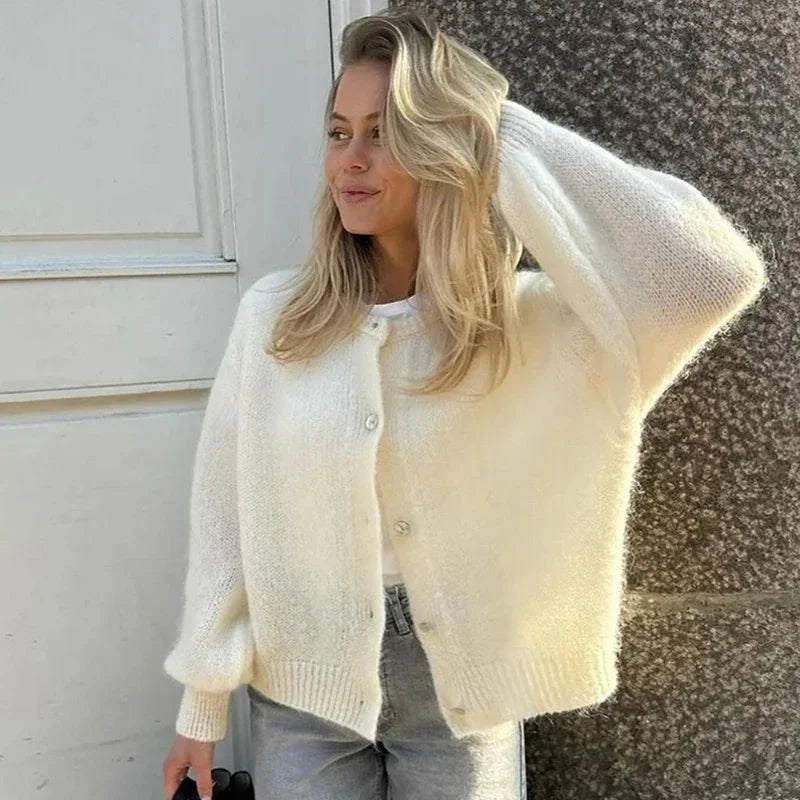 Women's animal print button-up cardigan made from soft knit fabric, featuring a classic collar and stylish button closure.