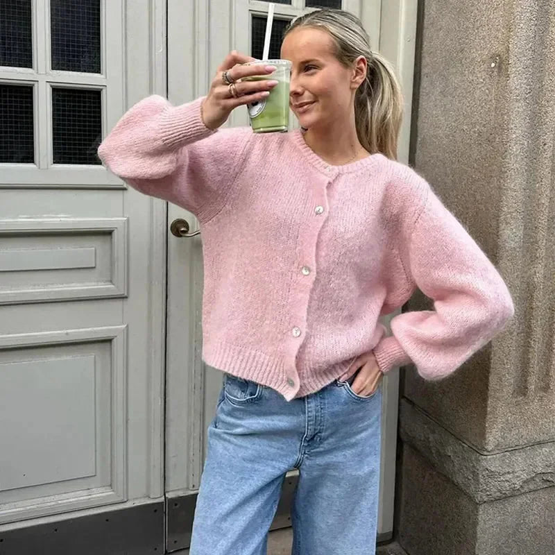 Women's animal print button-up cardigan in soft knit fabric with a relaxed fit and classic collar for versatile layering.