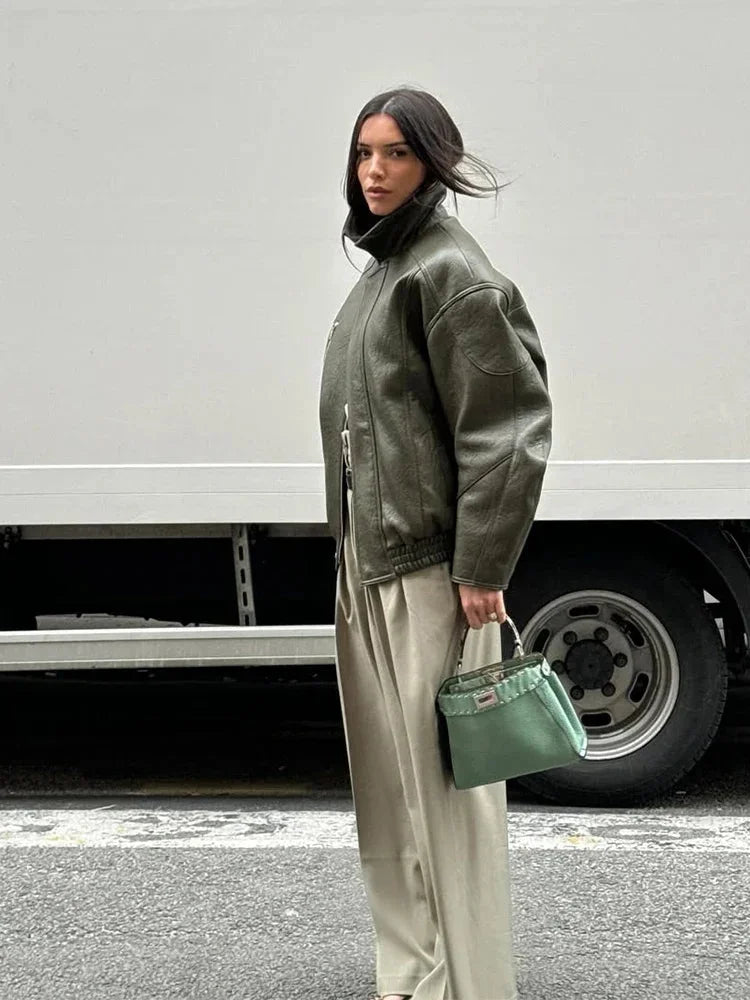 Women's army green jacket featuring a zip closure and stand collar, made from durable fabric for casual wear and versatility.
