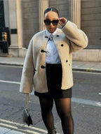 Women's beige coat featuring toggle closures, made from soft wool blend for comfort and warmth in casual settings.