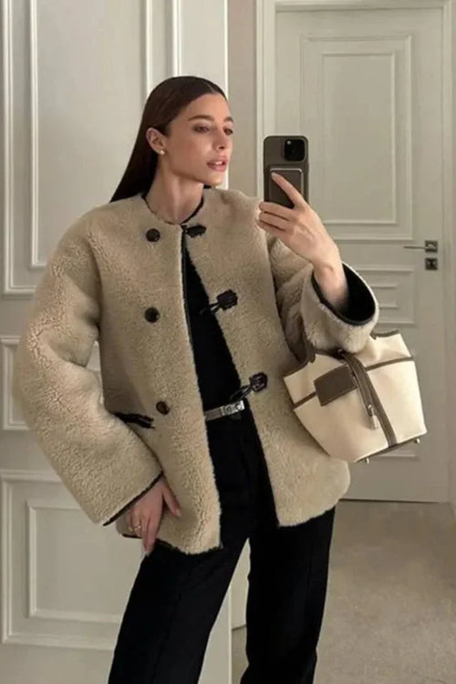 Women's beige coat featuring toggle closures, crafted from warm wool blend for comfort and style during chilly weather.