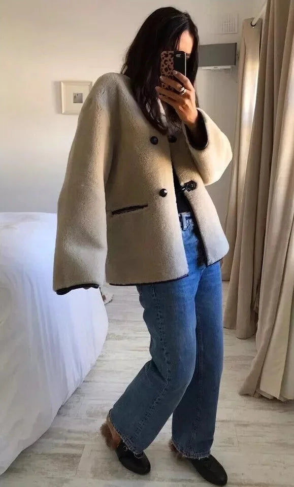 Women's beige coat featuring toggle closures, crafted from warm fabric for comfort and style on chilly days.