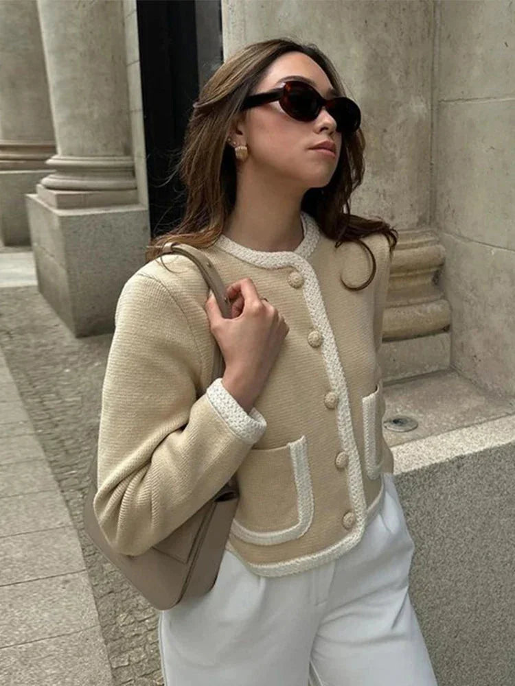 Women's beige cropped cardigan with button front, made from soft cotton blend, featuring a comfortable fit and ribbed…
