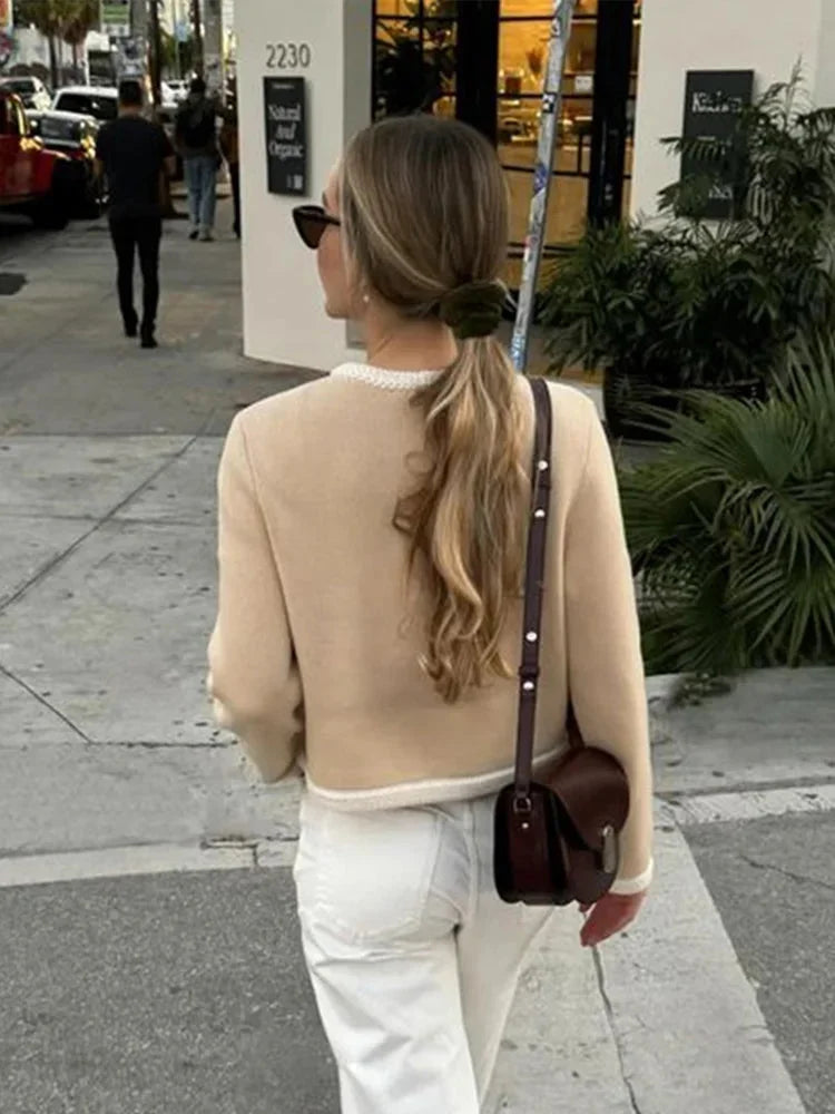 Beige cropped cardigan for women featuring a button front, made from soft cotton blend with a casual, versatile design.