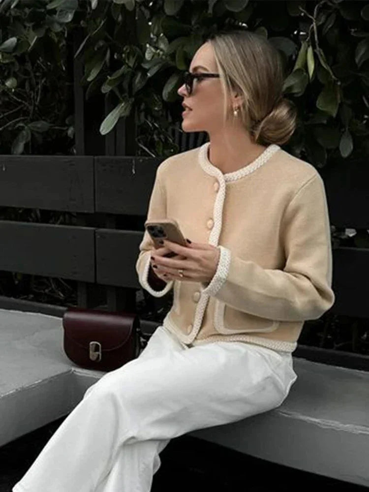 Women's beige cropped cardigan featuring a button front design, made from a soft knit material for comfort and style.