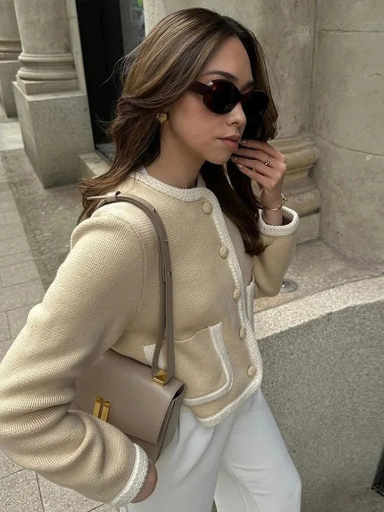 Women's beige cropped cardigan with button front, made from soft knit fabric, featuring a relaxed fit and ribbed cuffs.