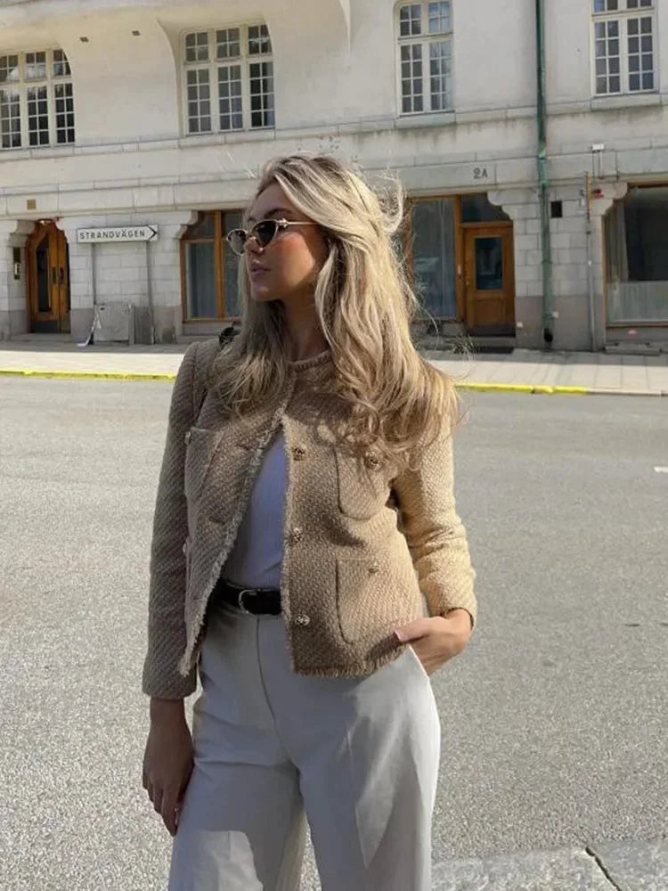Women's beige cropped tweed jacket featuring button details and a stylish tailored fit for a contemporary look.