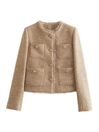 Women's beige cropped tweed jacket featuring button details, structured design, and texture for a versatile casual look.