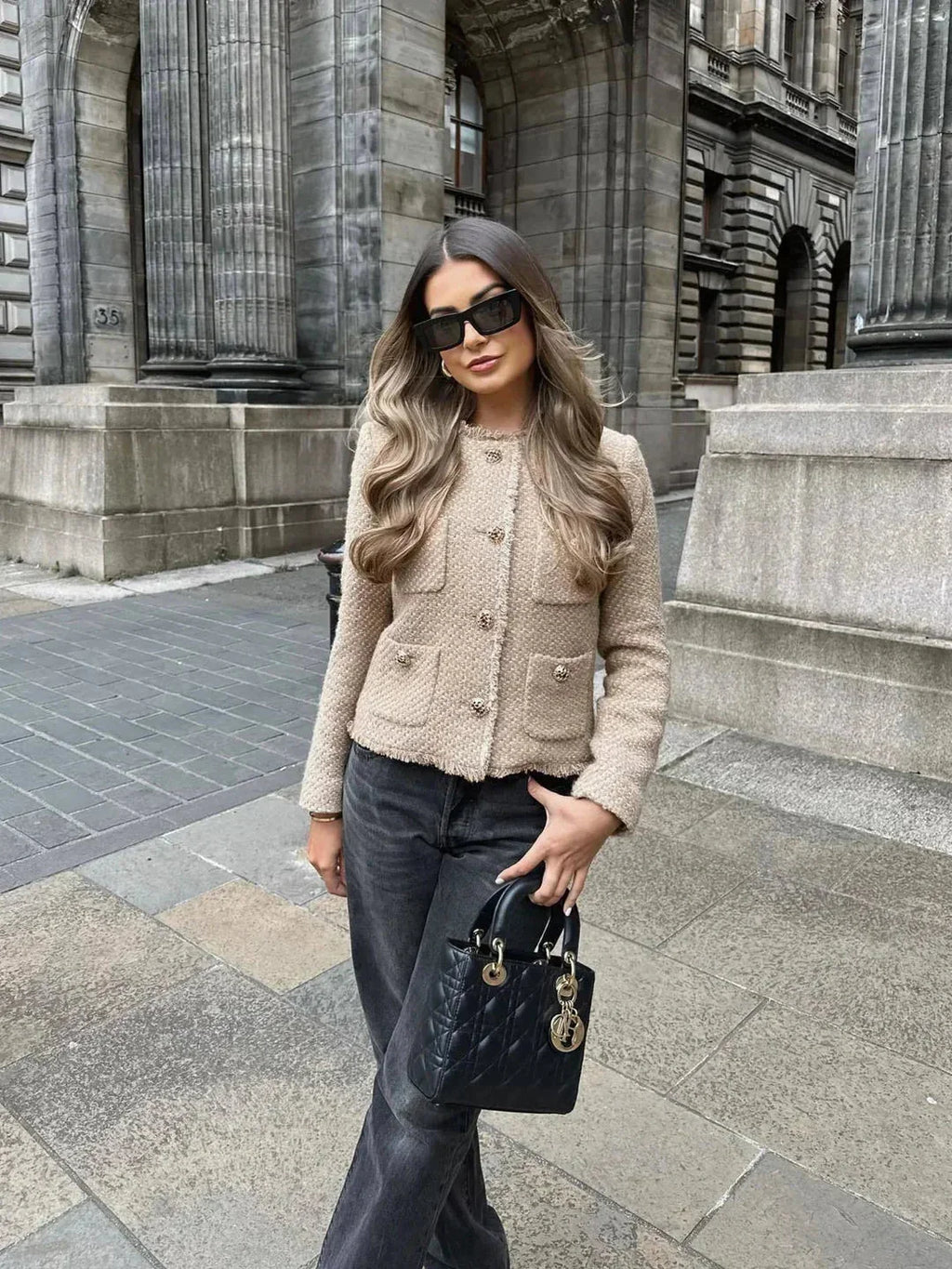 Women's beige cropped tweed jacket featuring a button front, textured fabric, and tailored fit for casual or formal wear.