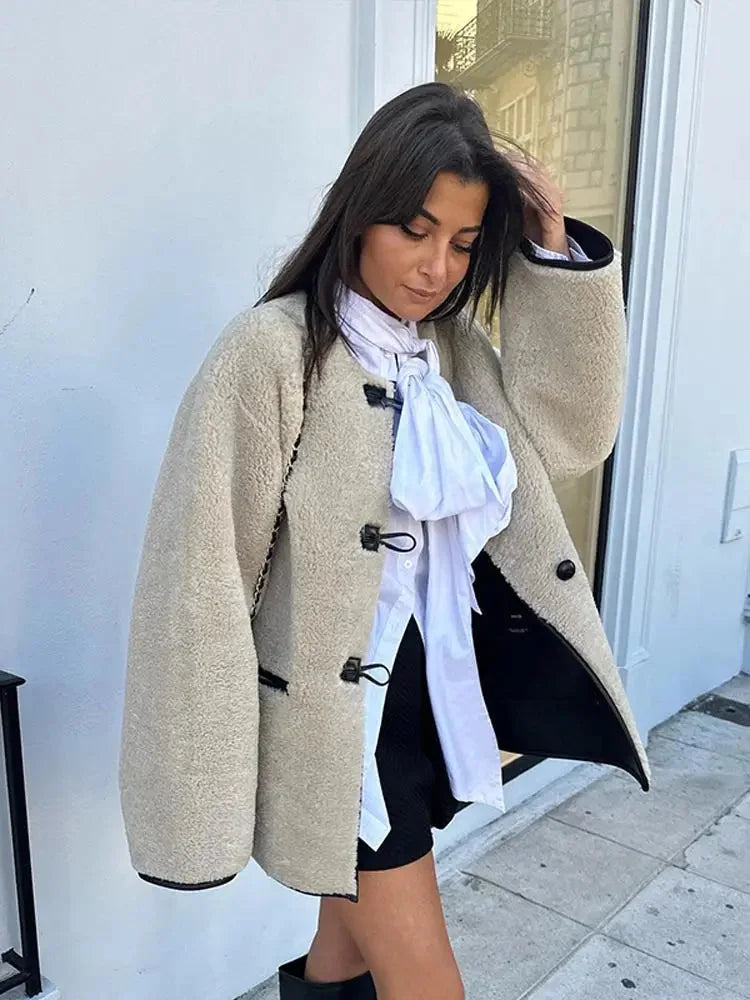 Women's beige fleece jacket featuring double-breasted buttons, soft material, and classic design for warmth and comfort.