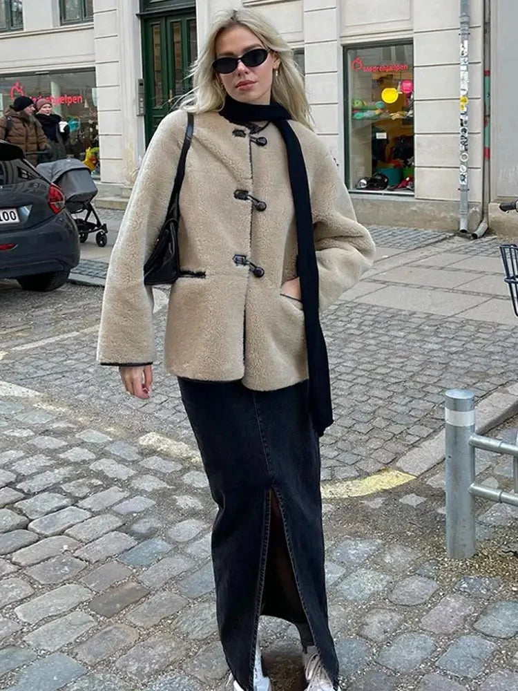 Women's beige fleece jacket featuring double-breasted buttons and a cozy, soft texture for warmth and comfort.