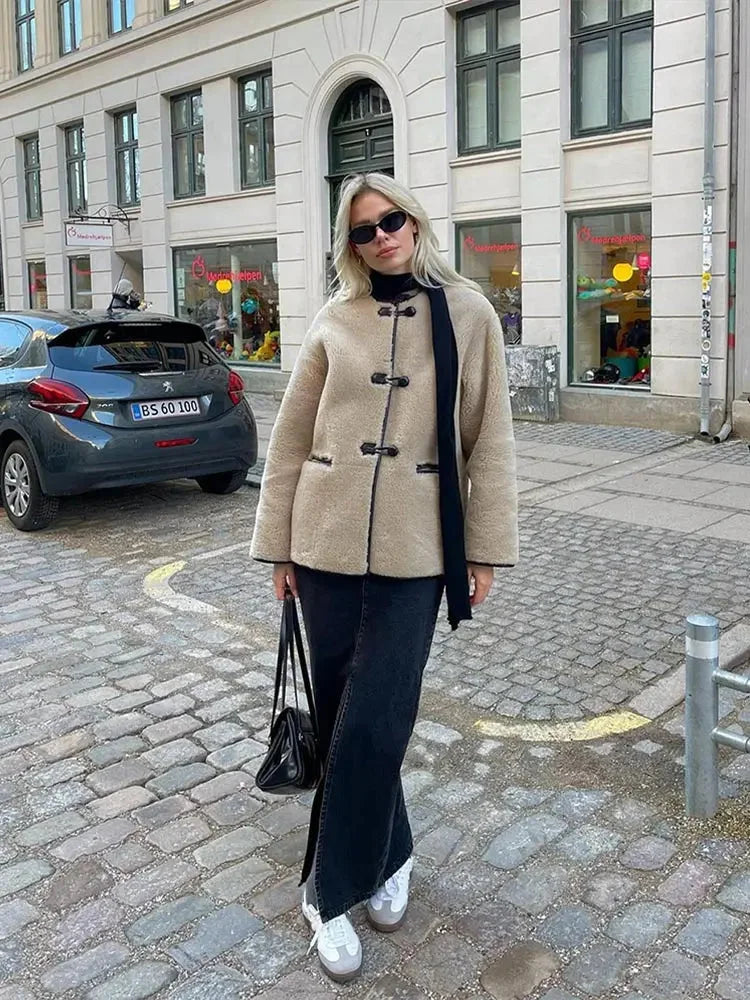 Women's beige fleece jacket featuring double-breasted buttons and a soft, cozy texture for warmth and comfort.