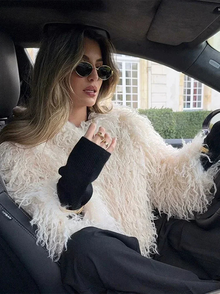 Women's beige long sleeve coat made of faux fur, featuring a relaxed fit and soft texture for warmth and comfort.