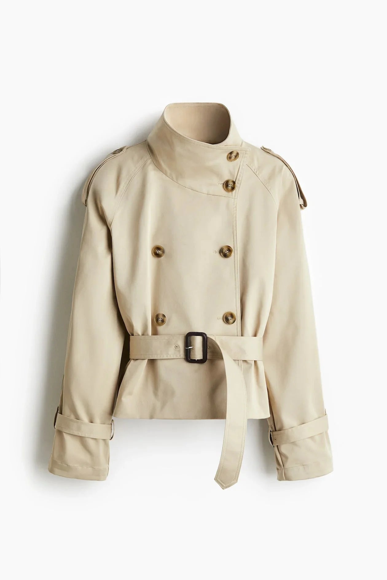 Women's beige short trench coat made of lightweight fabric, featuring a belted waist, double-breasted design, and classic…