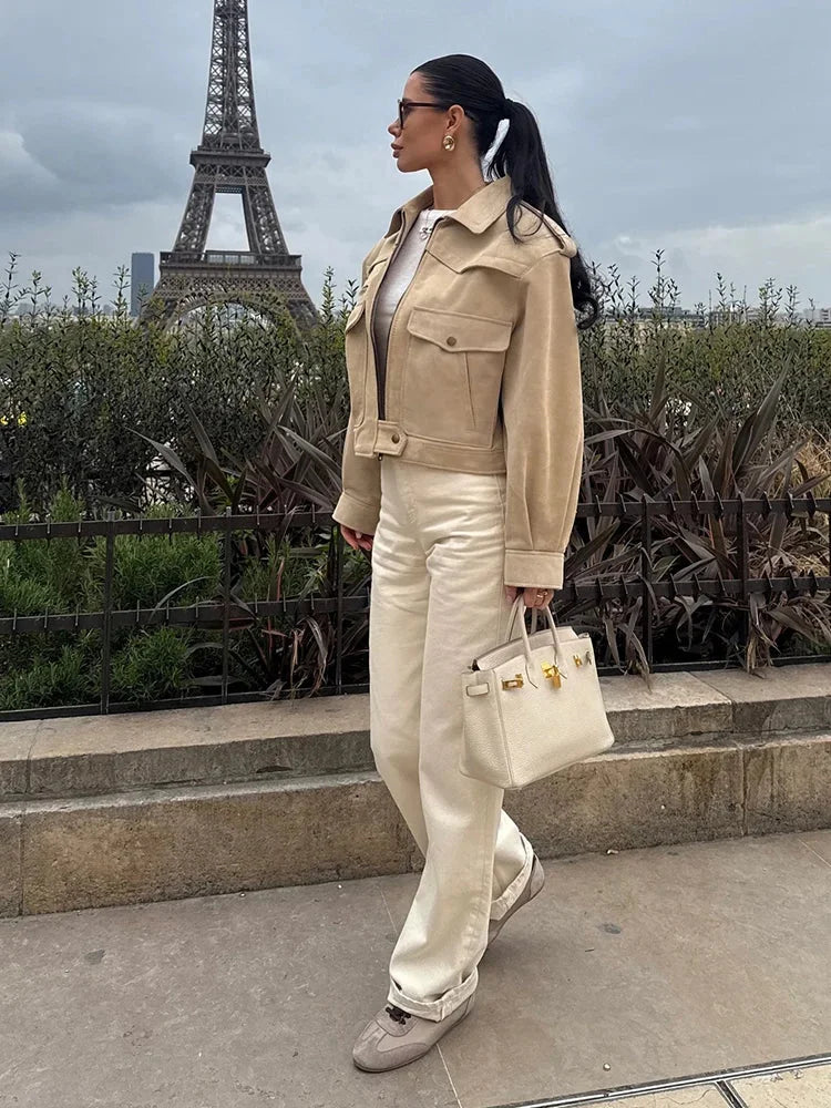 Women's beige suede cropped jacket featuring a classic lapel collar and sleek, contemporary design for versatile styling.