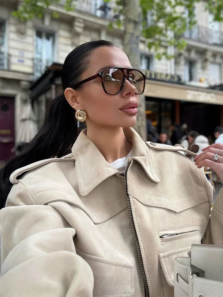 Women's beige suede cropped jacket featuring a stylish lapel collar and soft texture for a chic, casual look.
