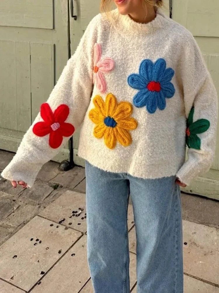 Women's beige sweater featuring a colorful floral design, crafted from soft cotton for comfort and style.