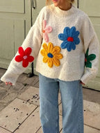 Women's beige sweater featuring a colorful floral design, crafted from soft cotton for comfort and style.