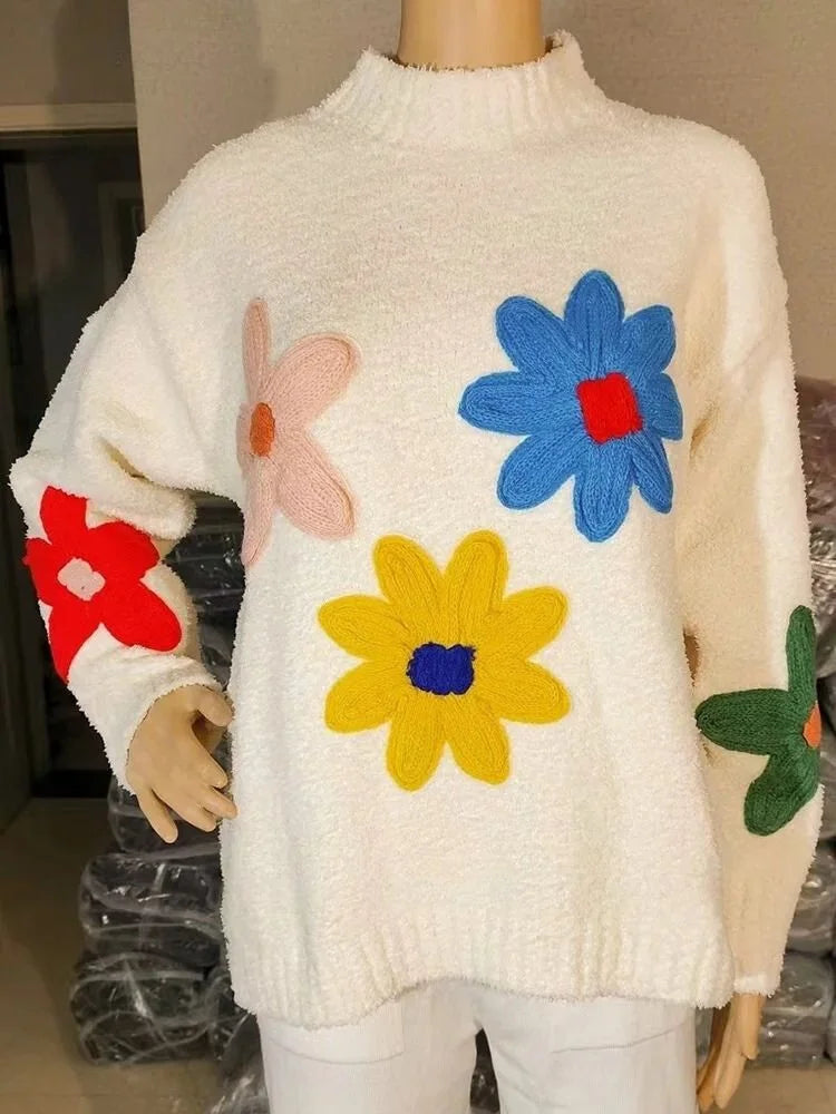 Women's beige sweater made from soft cotton, featuring a vibrant floral design for a casual and cheerful look.
