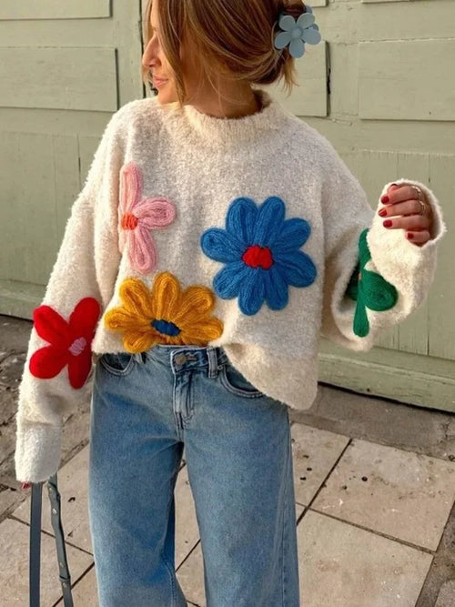 Beige women's sweater featuring a colorful floral design, made from soft, breathable fabric for comfort and style.