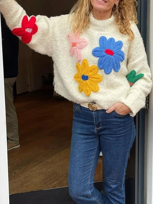 Women's beige sweater featuring a colorful floral design, made from soft cotton for comfort and warmth.