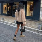 Women's beige teddy jacket featuring detailed stitching and a soft, cozy texture, perfect for cool weather layering.