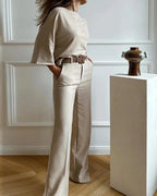 Women's beige two-piece set featuring a belted top and wide-leg pants made from soft, breathable cotton blend fabric.