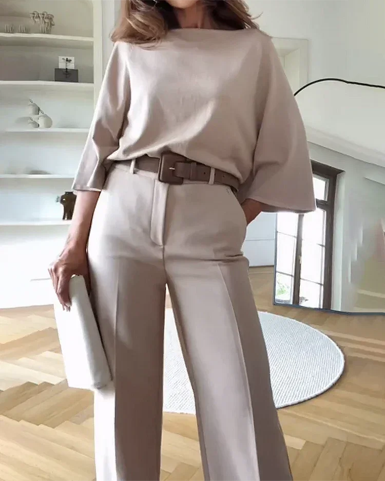 Women's beige two-piece set featuring a belted top and matching pants, made from soft, lightweight fabric for comfort.