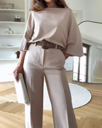 Women's beige two-piece set featuring a belted top and matching pants, made from soft, lightweight fabric for comfort.