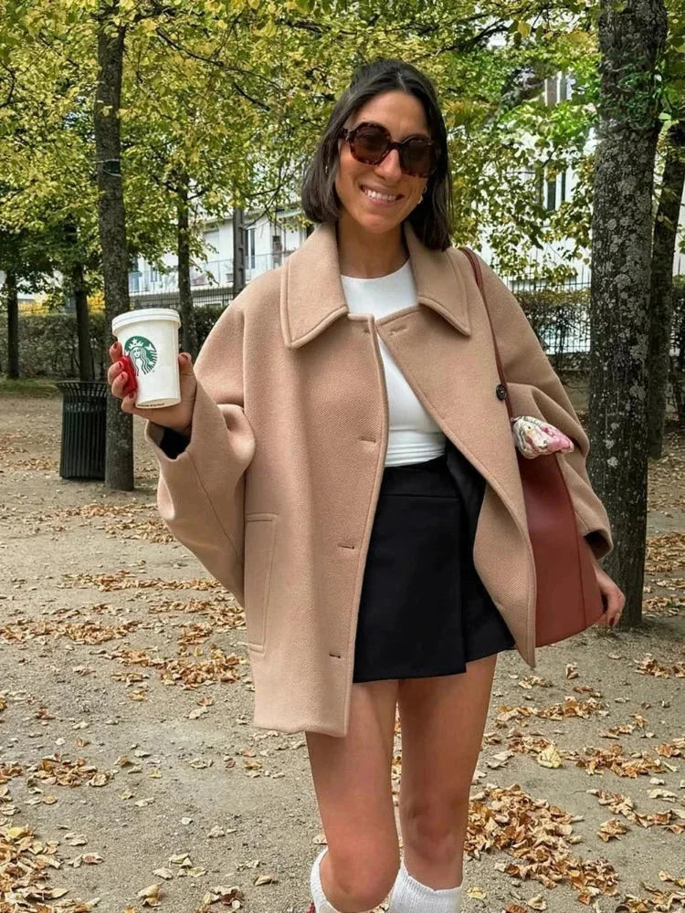 Women's beige oversized coat, vintage-inspired design, made from soft cotton blend with large buttons and spacious pockets.