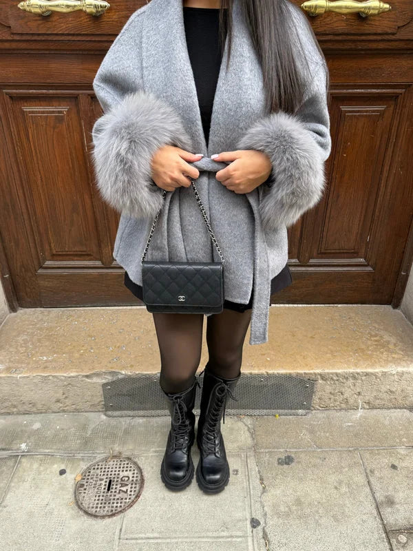 Women's belted coat featuring plush cuffs, made from warm fabric for comfort, with a tailored fit and stylish design.