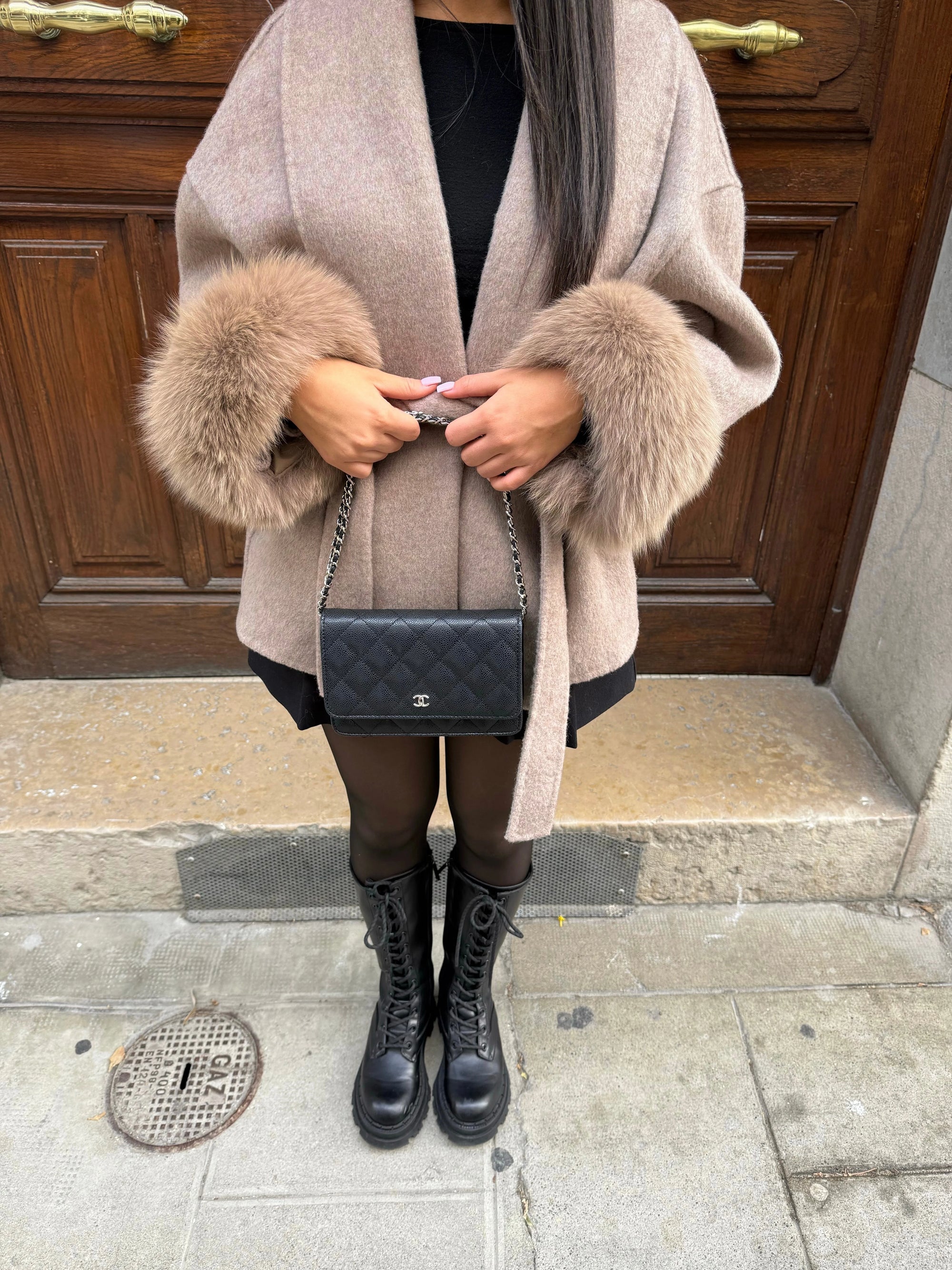 Women's belted coat featuring soft plush cuffs, made from warm fabric, perfect for stylish layering in cooler weather.