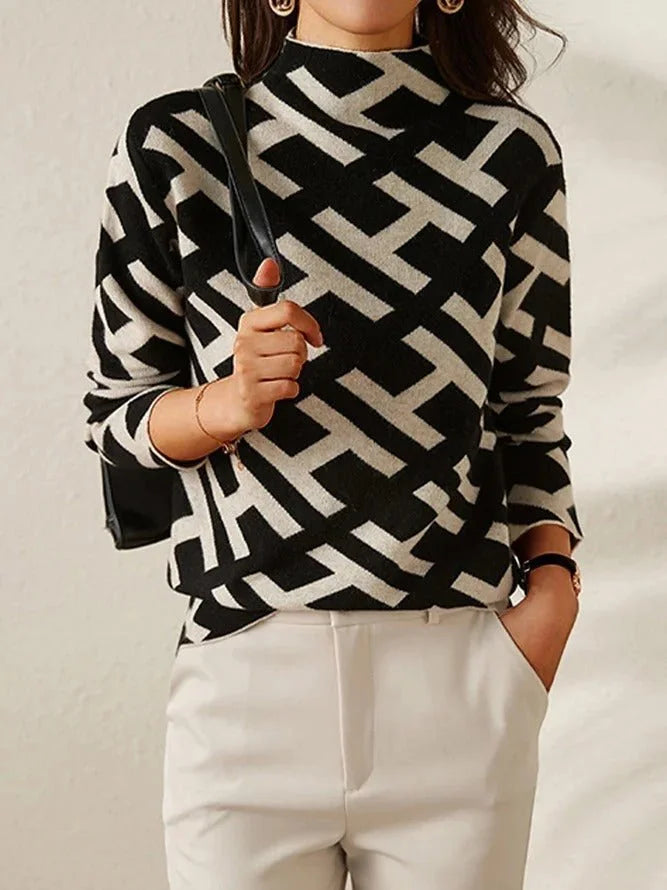 Women's black and white geometric pattern sweater made of soft knit fabric, featuring a modern design for casual wear.