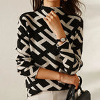 Women's black and white geometric pattern sweater made from soft knit fabric, featuring a cozy crew neckline and long…