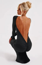 Women's black long sleeve open back bodycon maxi dress made from stretchy fabric, featuring a fitted silhouette and elegant…