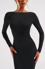 Women's black long sleeve bodycon maxi dress with an open back, made of stretchy fabric for a flattering fit.