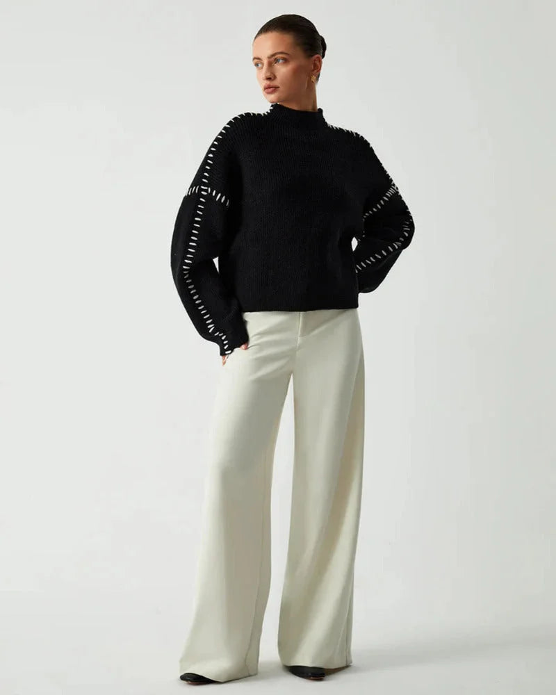 Women's black sweater featuring white stitch detail, made from soft cotton blend, perfect for casual layering in cooler…