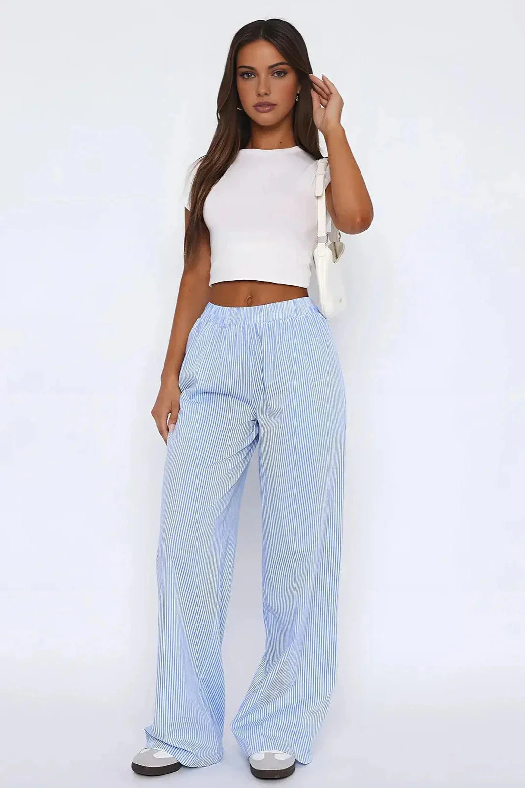 Women's blue striped wide-leg pants featuring an elastic waist and breathable fabric for comfort and ease of movement.