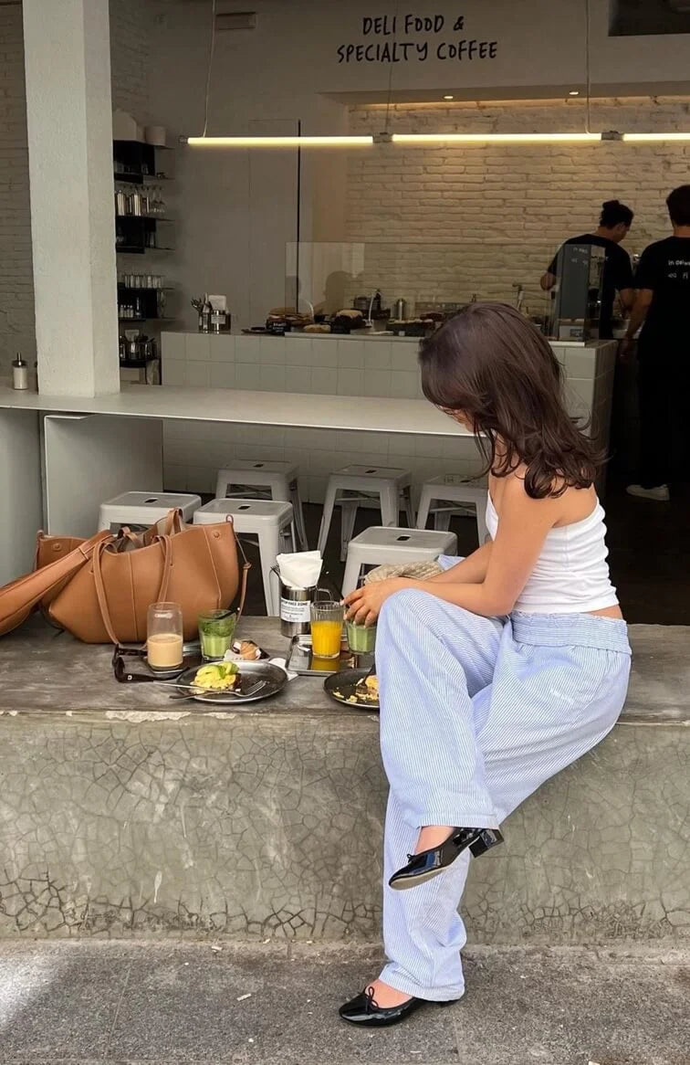Women's blue striped wide-leg pants made from breathable fabric, featuring an elastic waist for comfort and relaxed fit.